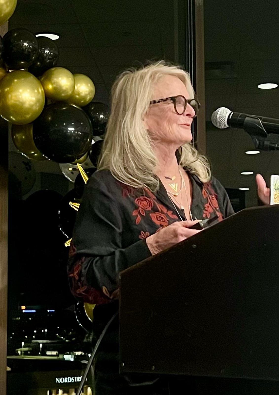 Carolyn Costin speaking to an audience.
